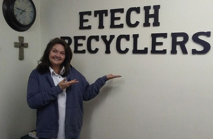 kim the owner next to etech sign