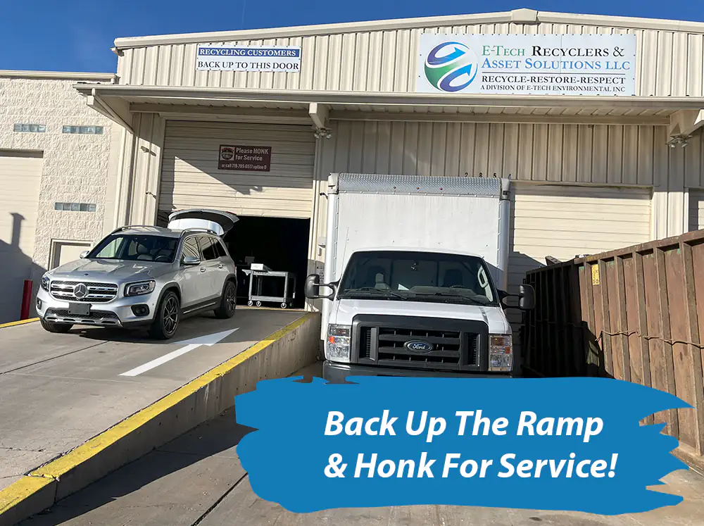 photo of vehicle backing up ramp outside etech recyclers to drop off tv